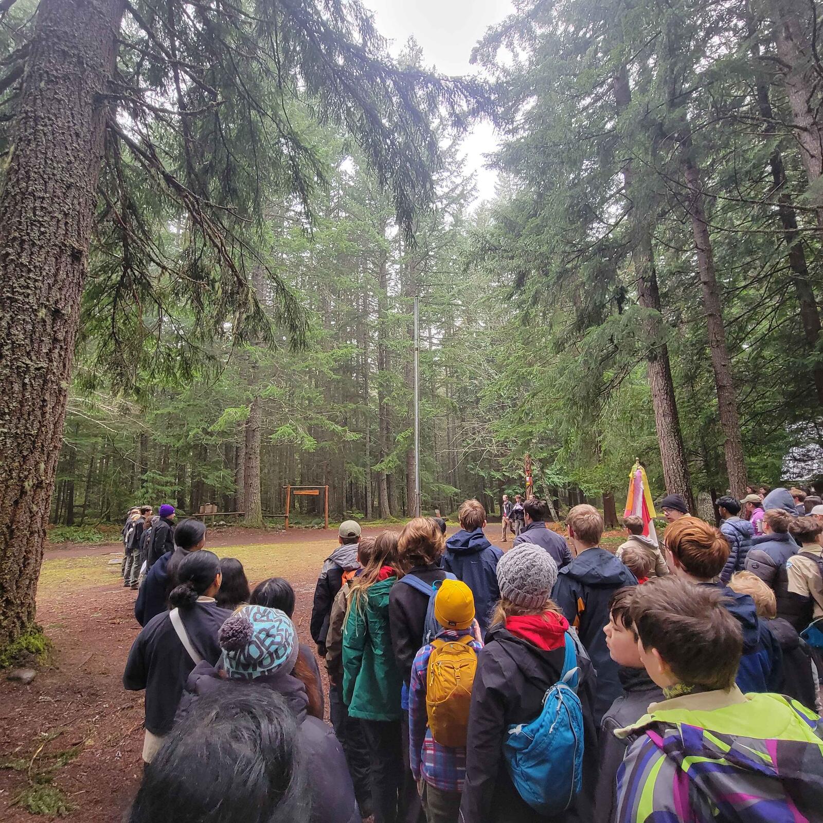 Scouts gathered for a morning assembly in the woods at Camp Sheppard